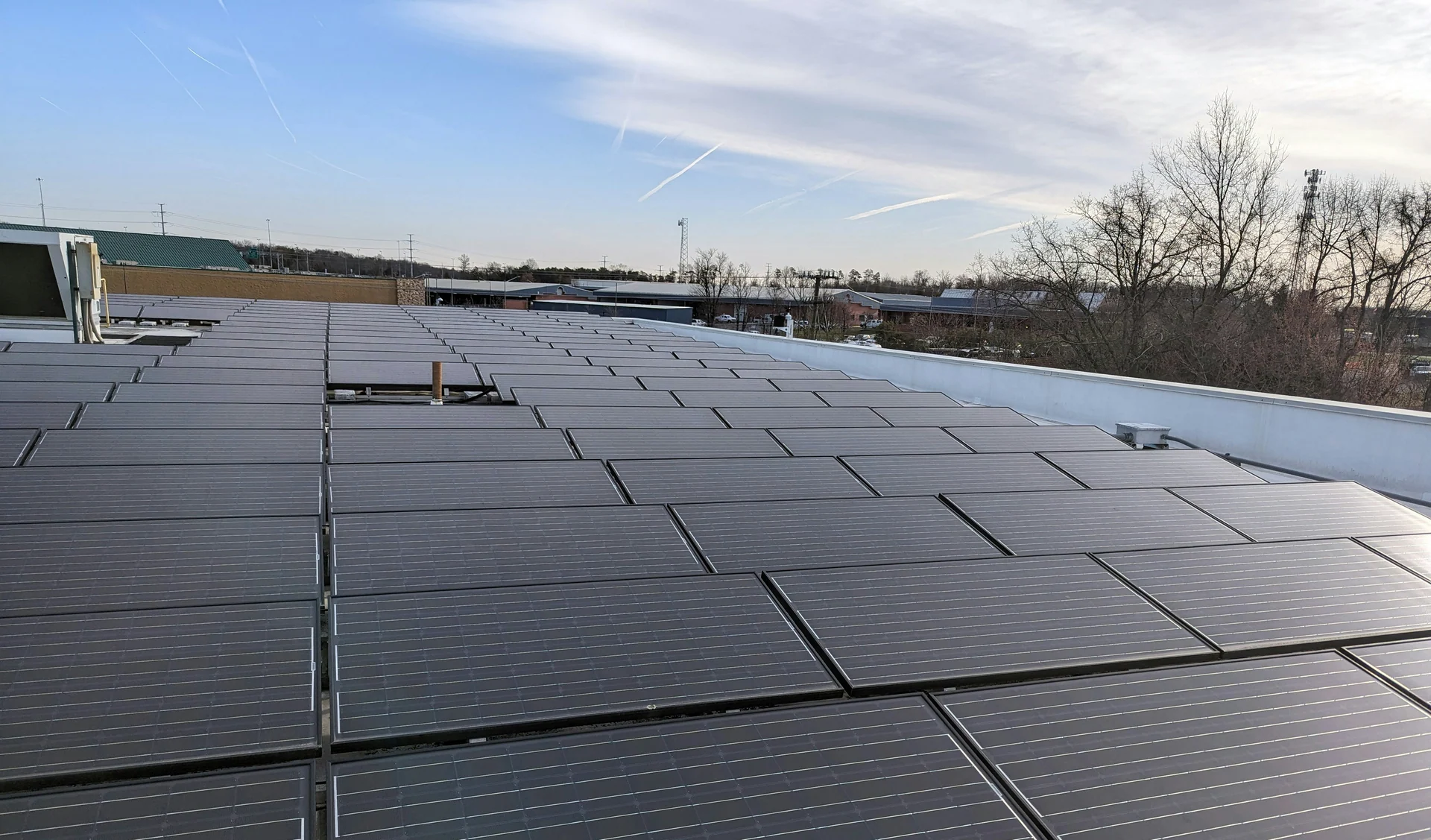 Close view of solar panels covering a commercial building roof